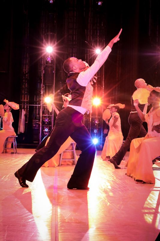 Alvin Ailey American Dance Theater's Tyrone Reese and company members in Alvin Ailey's Revelations. Photo by Xavier Mack