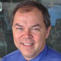 George Mejicano, M.D., M.S. - A man with light brown hair, smiling, in a blue shirt.