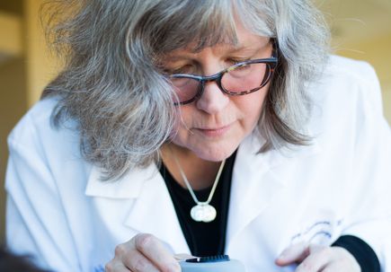 Sancy Leachman, M.D., Ph.D., performs a skin check.