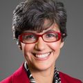 Maria Fleseriu, M.D., has short dark gray hair, red eye glasses and a red coat.
