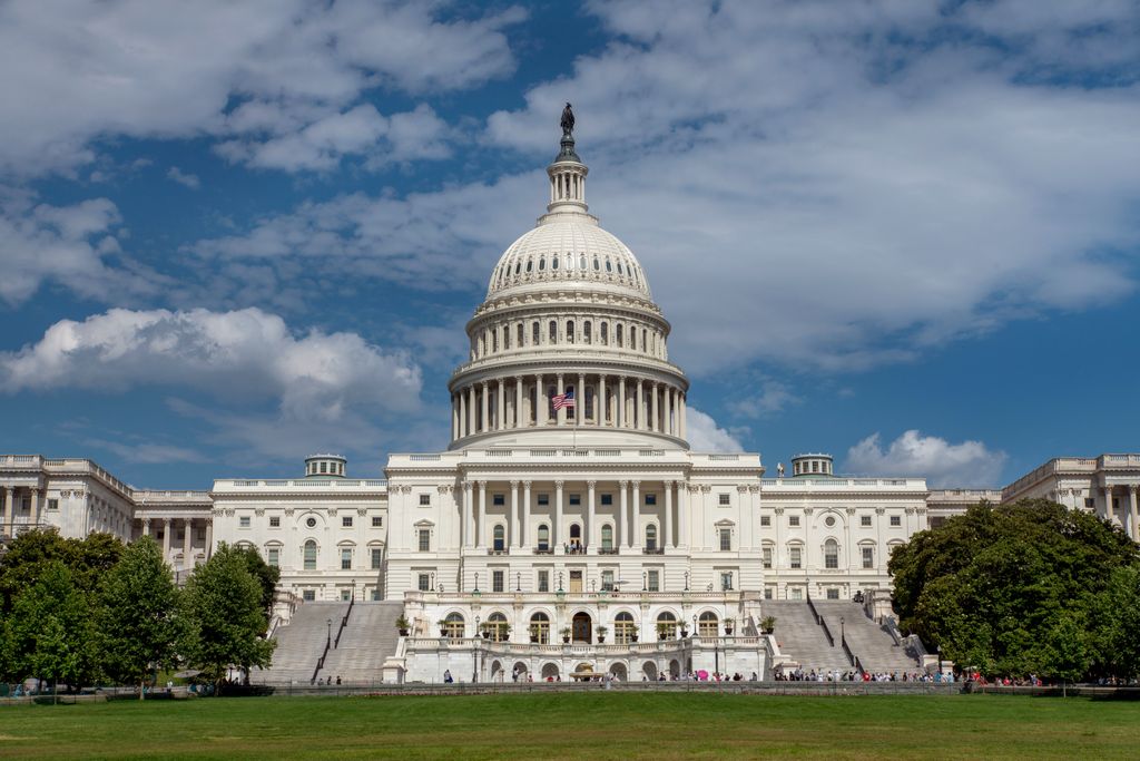 u.s. capitol building, with a blue sky and light white clouds