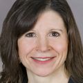 headshot of christie naze, dark hair, smiling at camera