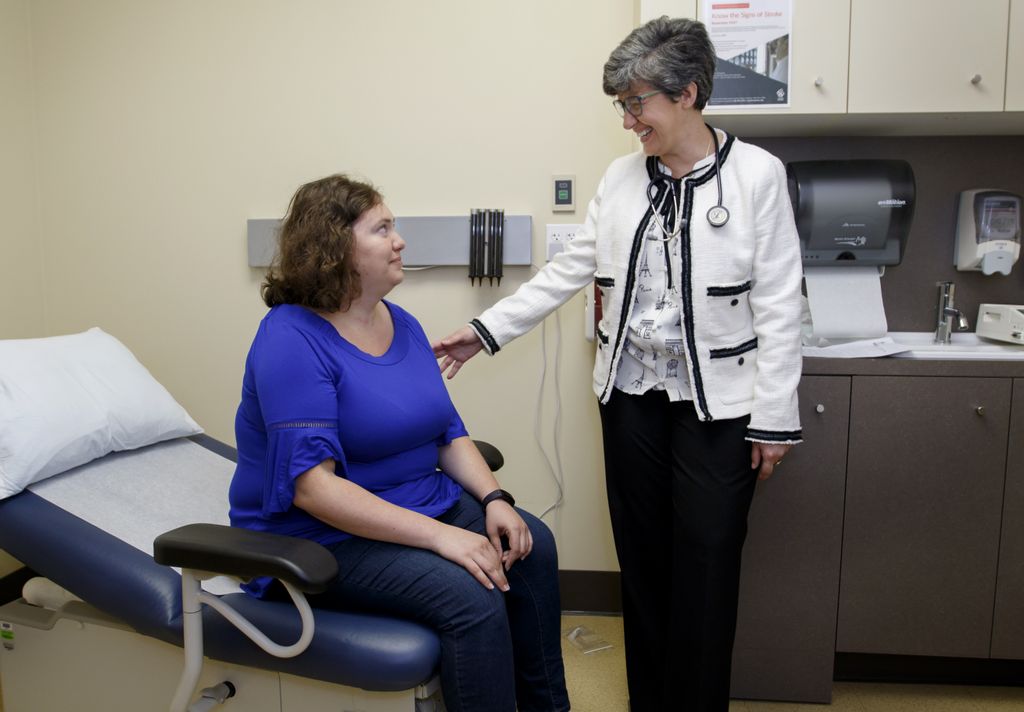 patient and doctor, talking in exam room