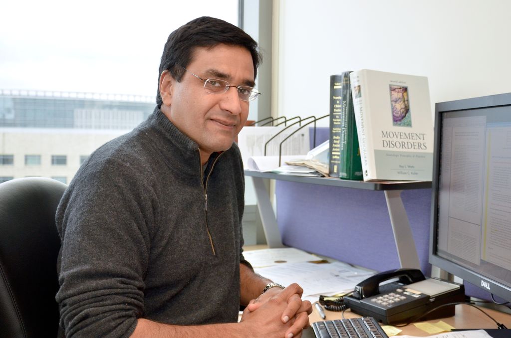 Vivek Unni, M.D., Ph.D., sitting at his desk