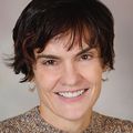 Jessica Gregg, M.D., Ph.D., smiling against a light brown background.