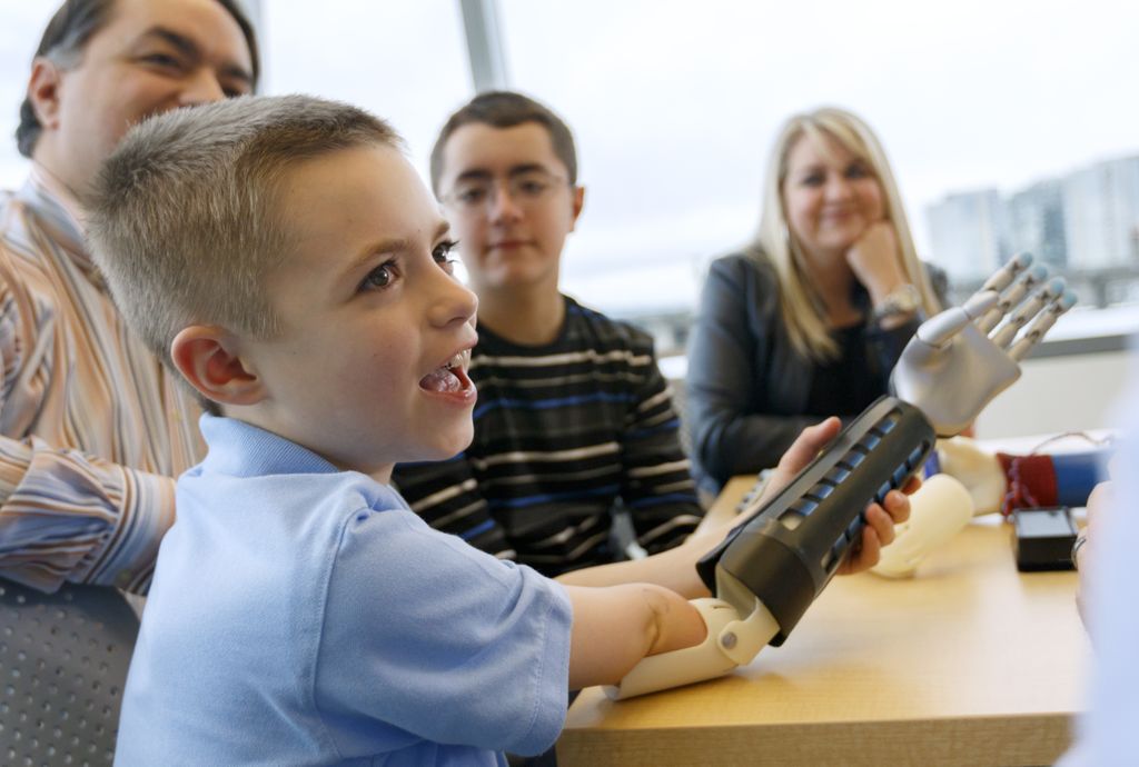 young boy wearing a prosthetic bionic arm