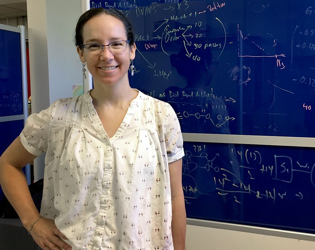 woman standing near chalkboard