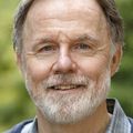 Erick Turner, M.D. A man with a gray beard, short hair, smiling.