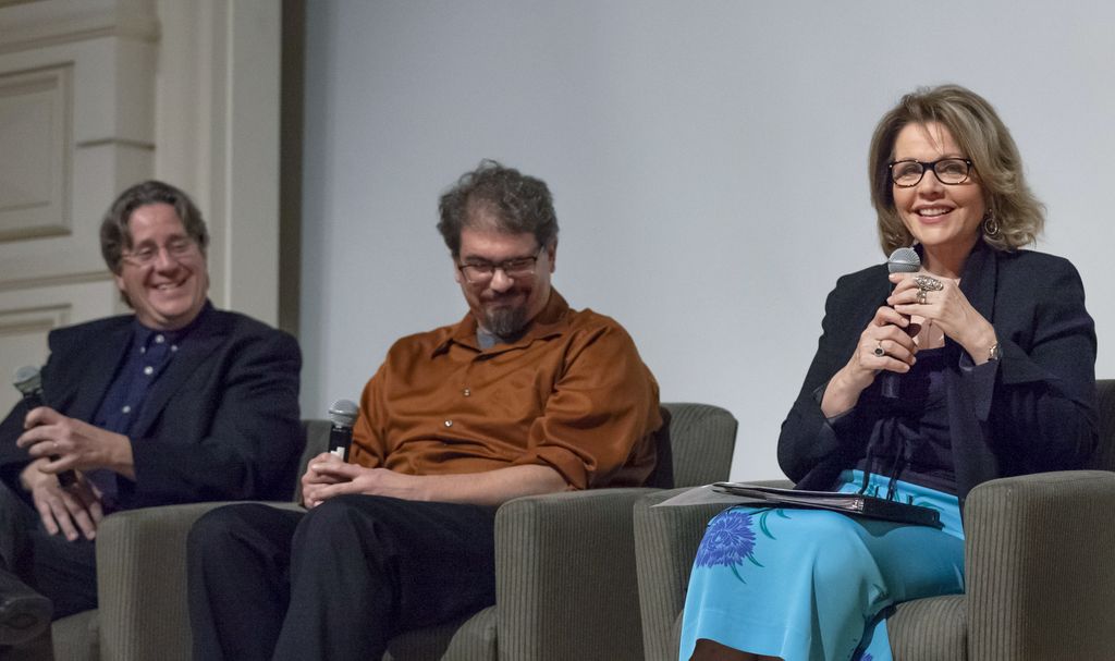 people on stage speaking in front of an audience