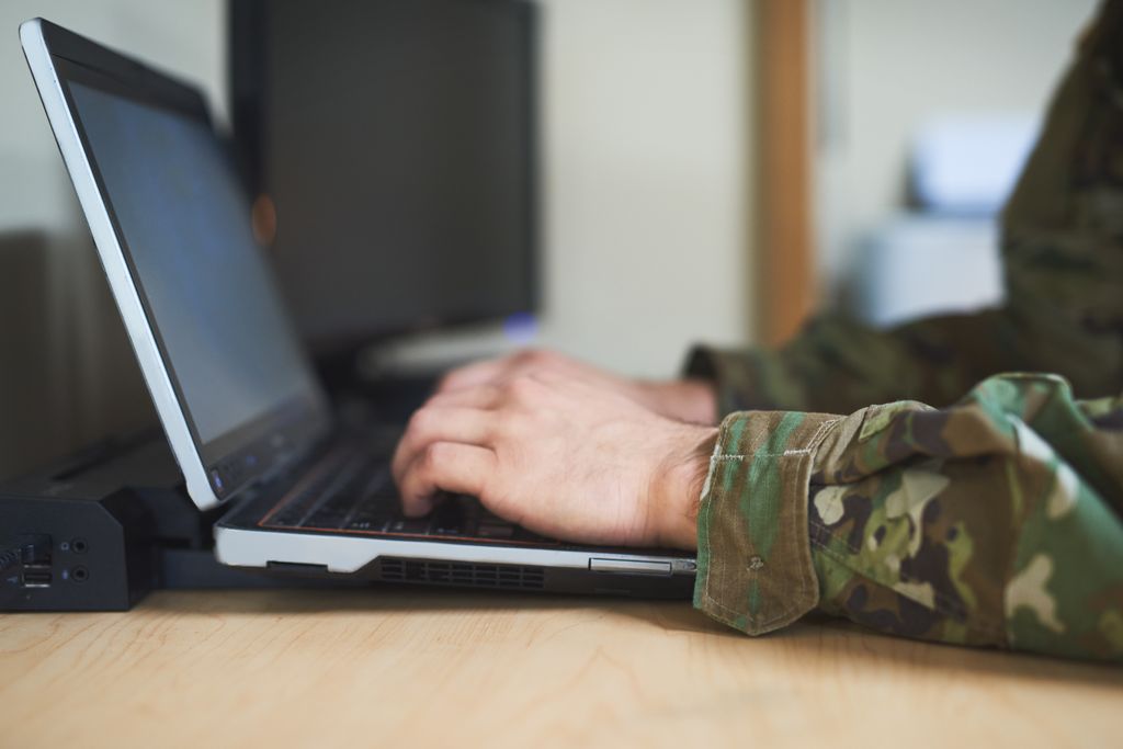 Soldier looks at screen.