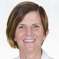 Christina Milano, M.D. (OHSU) a person with short brown hair, smiling.