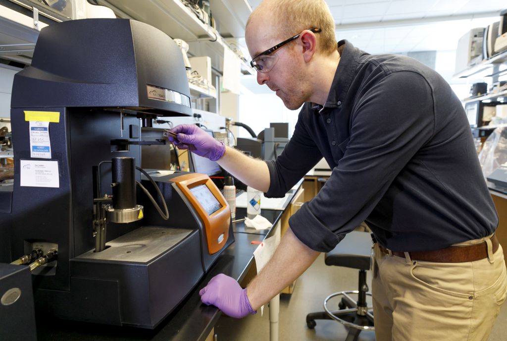 researcher programming a machine