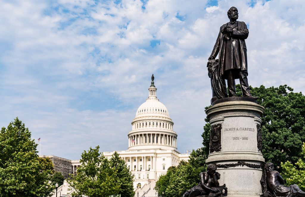 image of white house with a statue of president garfield on the right