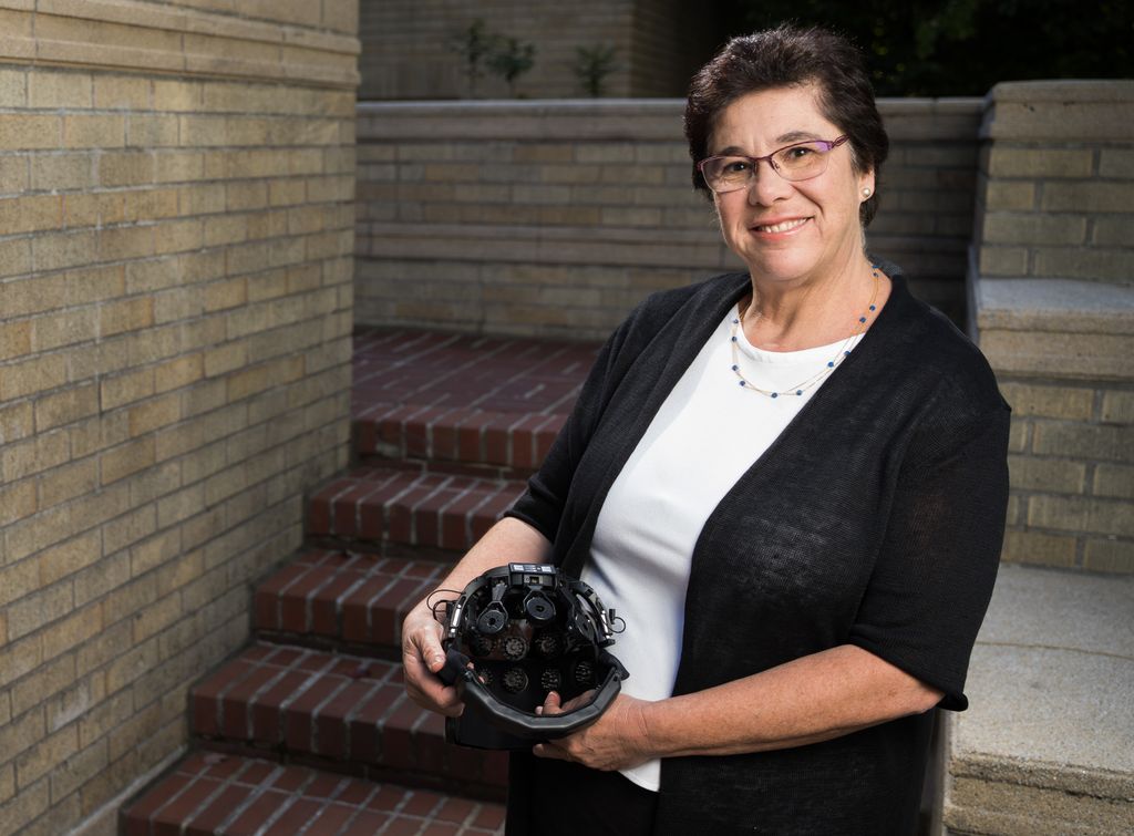 melanie fried-oken, holding a piece of equipement