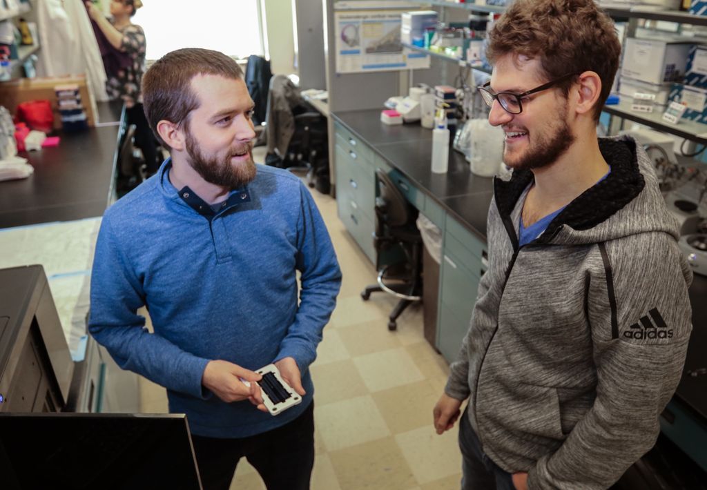 two scientists talking in lab
