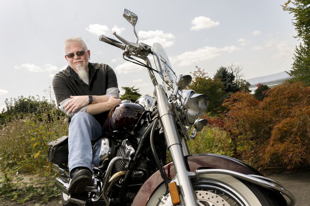 Brian Matekovich, sitting on his motorcycle and looking at camera