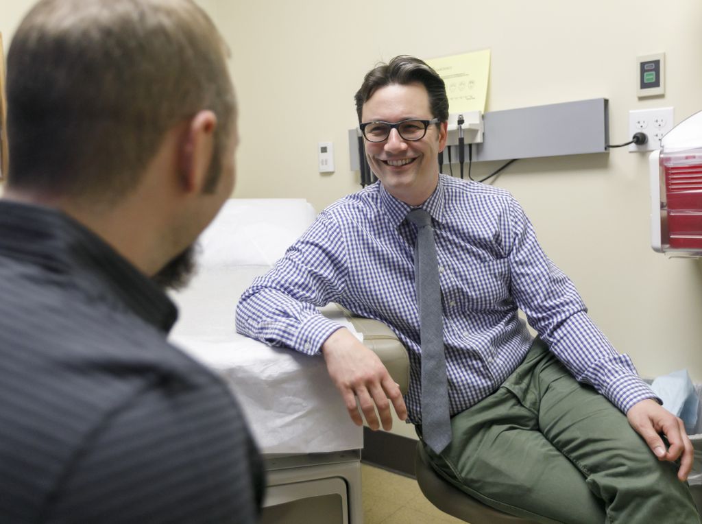 dr berli on right, talking and smiling with a patient