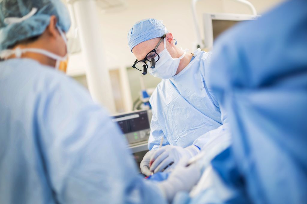 doctor in scrubs performing surgery