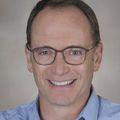 close-in head shot of Benjamin Hoffman, M.D., F.A.A.P., a smiling man in glasses.