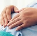 Pregnant woman lying on the bed waiting to give birth in a hospital.