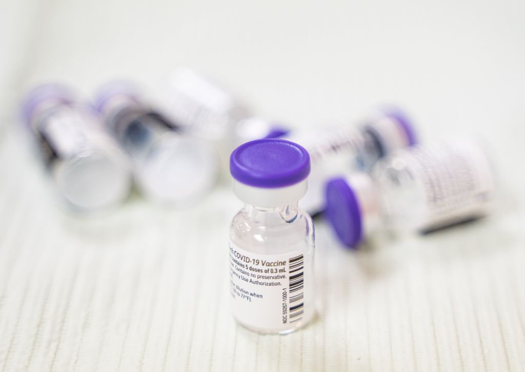 Pfizer COVID-19 vaccines on a table.