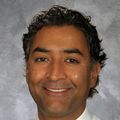 Devan Kansagara, M.D., M.C.R. (OHSU) in front of a gray and white marble background.