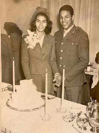 old photo of a young bride and groom about to cut a cake