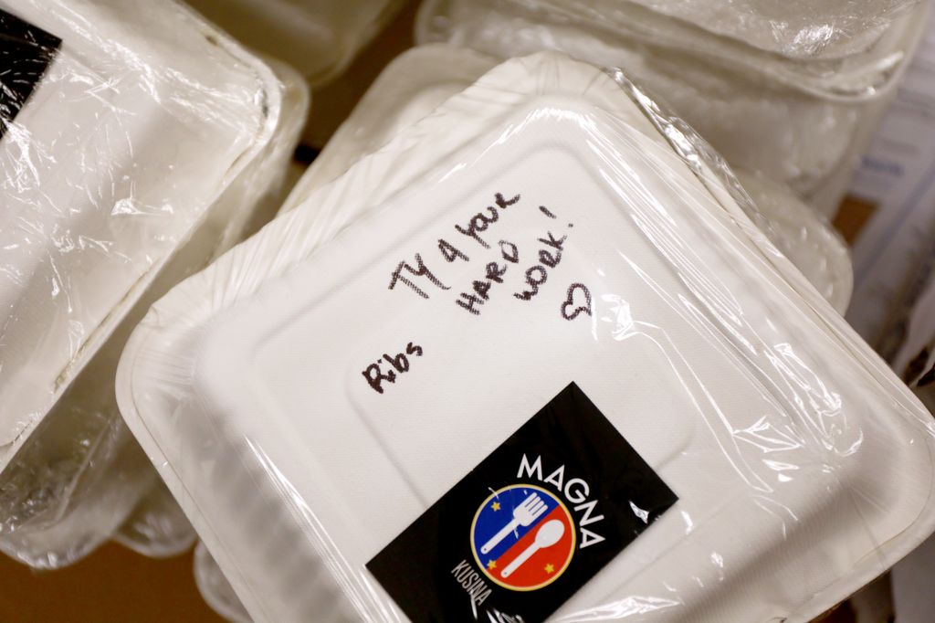 a container with food inside, with a handwritten message saying thank you