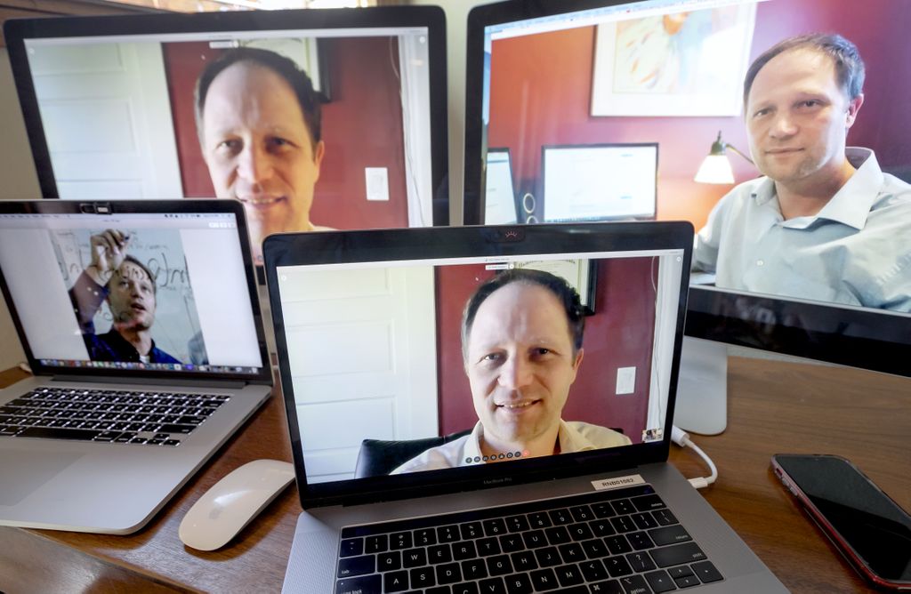 four computer monitors, all with peter graven's image in them. caucasian man, smiling