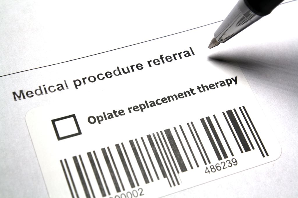 a pen about to check a box on a medical form for opioid treatment