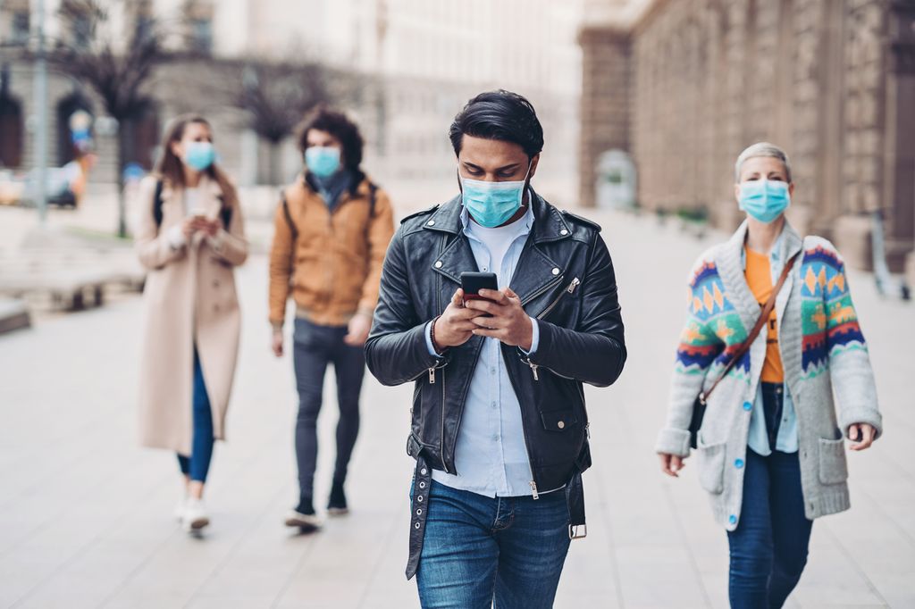 people walking in public, wearing protective masks