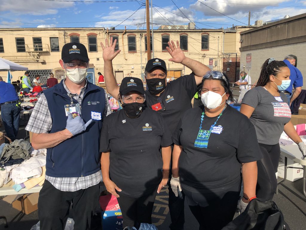Four masked volunteers pose together.
