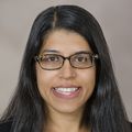 Headshot of Monica Sikka, M.D., a dark-haired, smiling woman with glasses.
