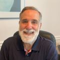 Headshot of Charles Roselli Ph.D., a man with a white beard in a dark polo shirt.