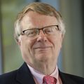 Headshot of Gordon Mills, M.D., Ph.D., a ginger-haired man in glasses and a suit