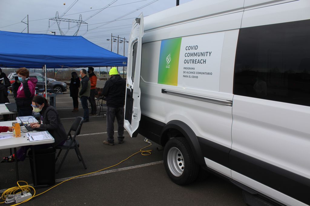 Photo of people around a white van