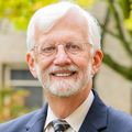 David Jacoby, M.D. stands near trees.
