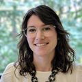Tamara Ostervoss, a woman with dark medium-length hair and glasses, in a white shirt smiling. (OHSU)