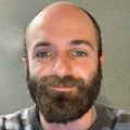 Benjamin Zemel, Ph.D. (OHSU) A man with fair skin and heavy facial hair smiling.