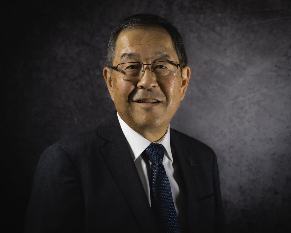 Ronald Sakaguchi Ph.D. D.D.S. M.B.A - a man wearing a suit, glasses.