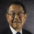 Ronald Sakaguchi Ph.D. D.D.S. M.B.A, with a gray background.