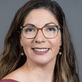 Ximena A. Levander, M.D., M.C.R. (OHSU), smiling against a gray background.