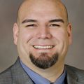 Close-in head shot of Ramon Barajas Jr., M.D., a pale, bald man with a dark goatee