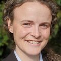 Close-up head shot of Brett Lewis, M.D., a smiling woman with curly hair