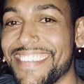 Close-in shot of Justin Davis, B.S., a smiling Black man with a beard