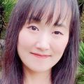 Close-in headshot of Jennifer Ku, M.P.H. Ph.D., a smiling Asian woman with long, dark hair