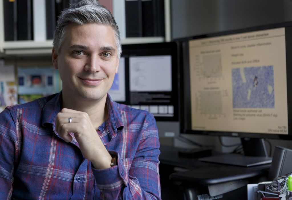 Jonah Sacha, Ph.D. sitting in his office at OHSU's Oregon National Primate Research Center and Vaccine & Gene Therapy Institute.