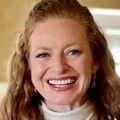 head shot of Mayme Marshall, M.D., a smiling adult woman with long, curly, red hair