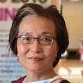Close-in headshot of Xuan Qin, Ph.D., an Asian adult female wearing glasses
