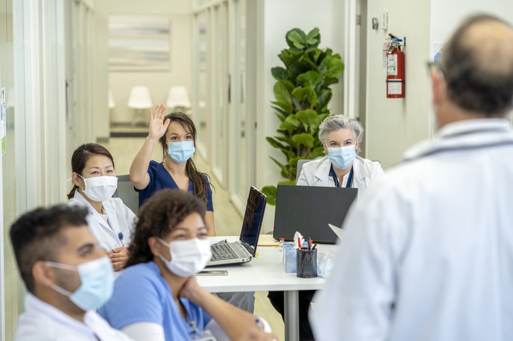 Group of medical students in a medical training class, all are wearing masks due to COVID-19.
